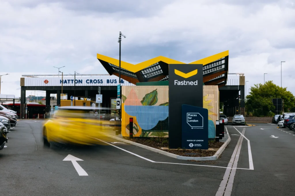 The distinctive yellow canopy of the Fastned EV chargers located in front of Hatton Cross Station.